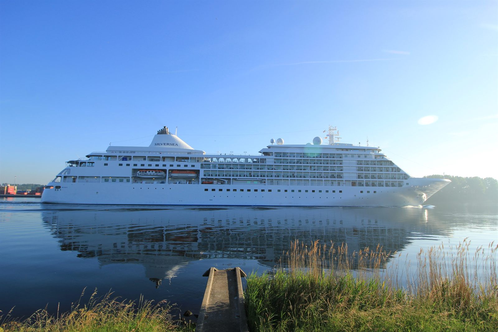 Silversea luxury cruise ship reflected in a calm northern harbor