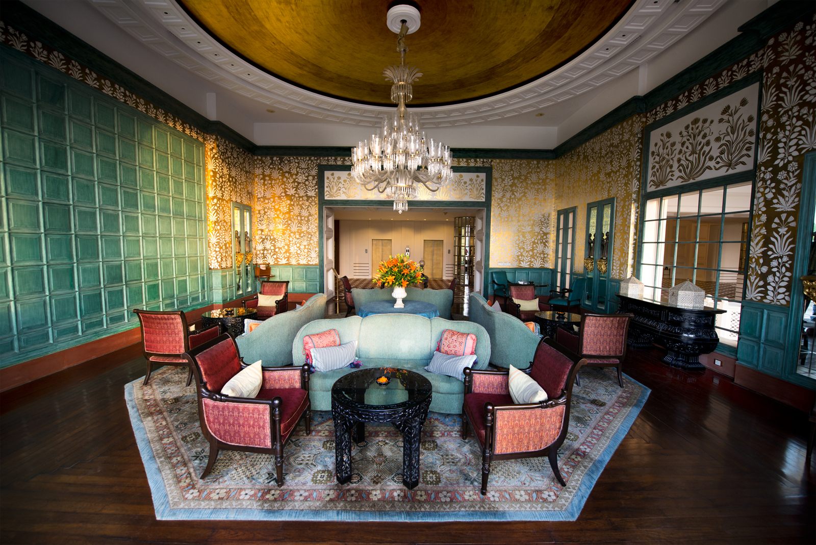 Ornate private lounge with chandelier, sofa and armchairs